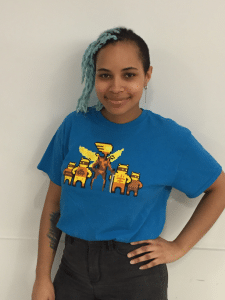 Blue Killer Queen T-Shirt worn by female model. Image courtesy of Alan from BumbleBear Games.